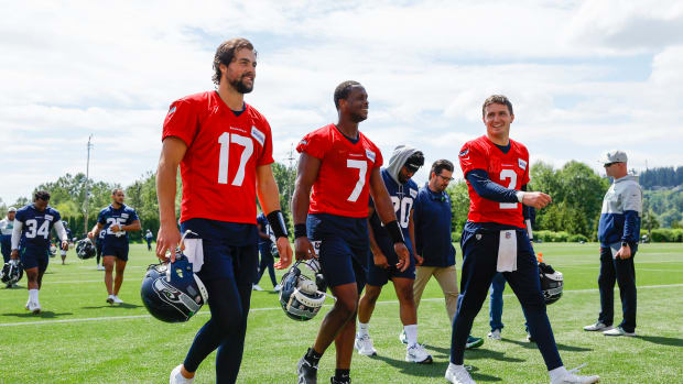Seattle Seahawks quarterback Jacob Eason (17), quarterback Geno Smith (7) and quarterback Drew Lock (2) talk while walking to the locker room following an OTA workout at the Virginia Mason Athletic Center.